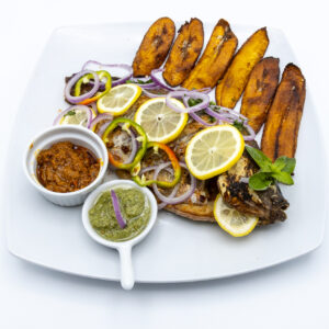 Roasted (smoked) Tilapia spiced Fish with Plantains and fresh cooked garlic source