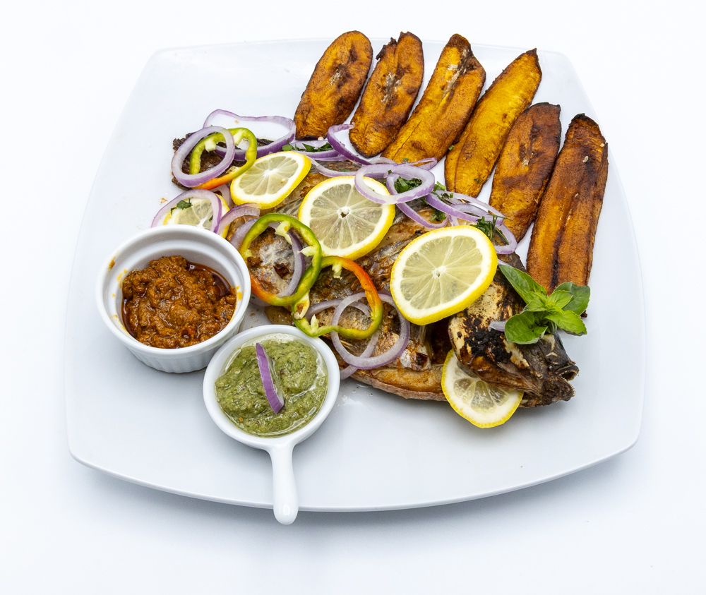 Roasted (smoked) Tilapia spiced Fish with Plantains and fresh cooked garlic source