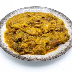 Ekwang ( Cocoyam paste folded in Taro leaves spiced with tropical country onion and Palm oil with smoked fish crumbs.(40 Ron)