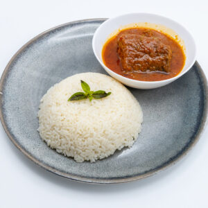 African Rice with a dish of tomato sauce with either fish or beef.